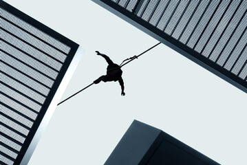 Man balancing on the rope challenge and risk taking concept