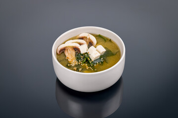 miso soup on bowl on black with reflection