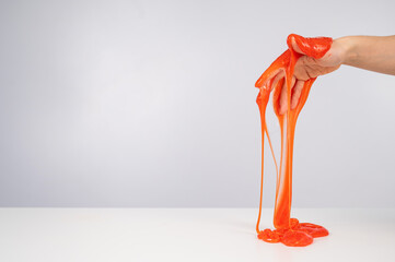 Red slime flowing down from a woman's hand on a white background. 
