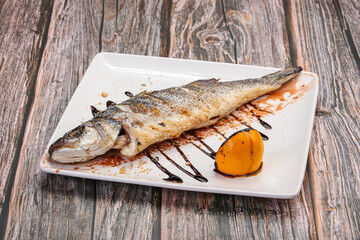Grilled seabass fish served lemon