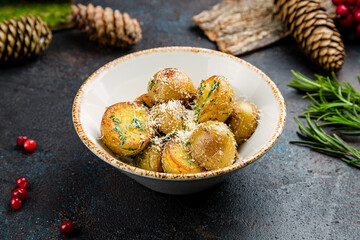 baked mini potatoes with greenery and cheese on plate