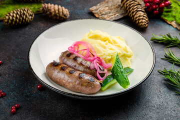 Fried hunter sausage with mashed potatoes and red onion, kupati on plate