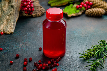 lingonberry juice in a plastic bottle on dark table © Алиса Королевская