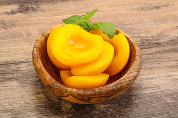 Sweet ripe canned peaches with mint