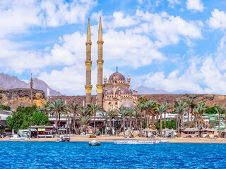 The coastline of the Old Market of Sharm El Sheikh - view from Sharm El-Maya Bay in the Red Sea. Exotic cityscape of an Egyptian tourist town in the Sinai desert with mountains in the background