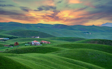 cottages in lumpy farm land in sunrise