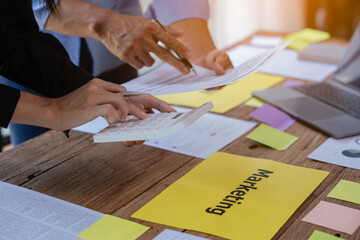 Close up of hands working and brainstorming on paperworks about business financial and marketing.