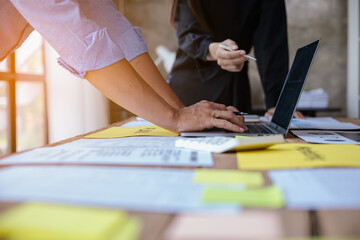 Close up of hands working and brainstorming on paperworks about business financial and marketing.