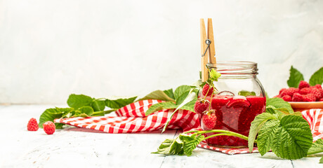 Jar of raspberry jam and fresh berries on a light background. Long banner format. place for text