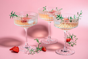 drink cocktail with ice in a glass on pink background. refreshing fruit cocktail or punch with wine...
