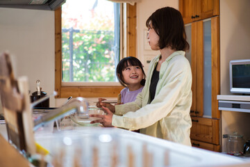 A girl cooking with her mother