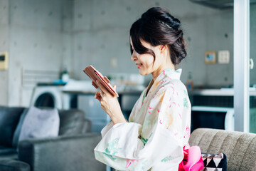 Young Woman in Yukata Dressing