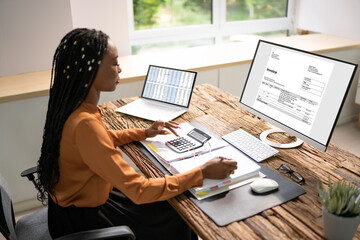 Accountant Calculating Tax At Desk