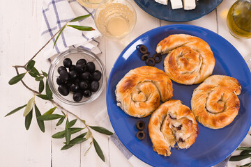 Pastry swirls with cheese and olive filling.