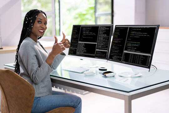 Computer Programmer Writing Program Code On Computer
