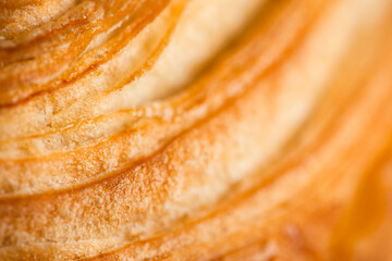 Croissant macro. French croissant with waves. Air baking. Croissant for puff pastry advertising....