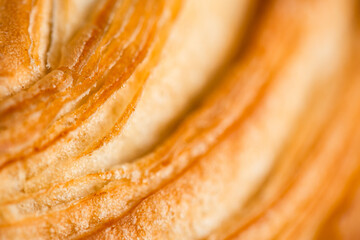 Croissant macro. French croissant with waves. Air baking. Croissant for puff pastry advertising. Croissant for a magazine.French breakfast with pastries. From puff pastry. Bun from France. Roll macro