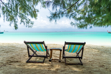 Colorful beach chairs on the beach in raining day.