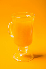 Sea buckthorn tea on yellow background