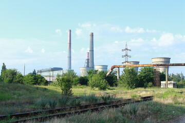 Fototapeta na wymiar Thermal power plant in operation. The smoke rises from the towers above the houses.Pollution