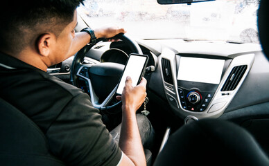 Person holding the cell phone and with the other hand the steering wheel, Distracted driver using the cell phone while driving, Man using his phone while driving, Concept of irresponsible driving