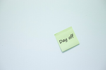 A sticky note on the concrete wall with Day Off message 