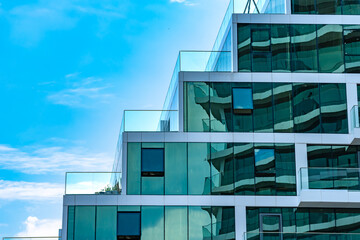 detail glass window, wall and balcony railing in modern building architecture over blue sky background - Powered by Adobe