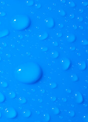 Macro shot with drops of water on a blue surface