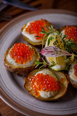 Potatoes from the oven with red caviar.