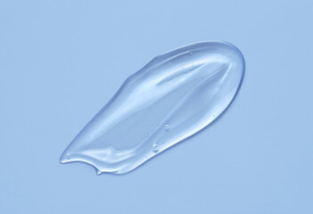 Cosmetic serum gel beauty swatch smear smudge on blue color background. Skincare beauty product with bubbles texture