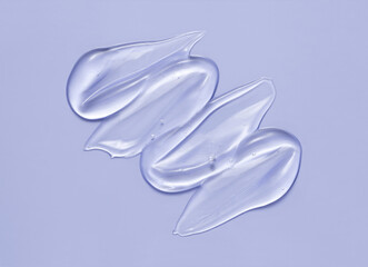 Cosmetic serum gel beauty swatch smear smudge on blue color background. Skincare beauty product...