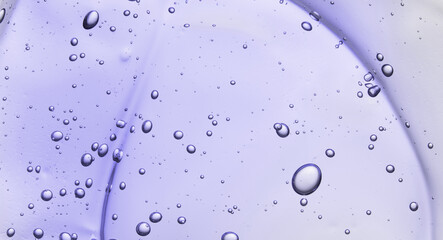 Liquid gel beauty serum texture. Beauty skincare liquid violet gel background with bubbles.Skincare...