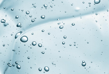 Liquid gel beauty serum texture. Beauty skincare liquid blue gel background with bubbles.Skincare hygiene product closeup.