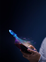 Futuristic Conceptual Photo. Startup Concepts. Rocket Take-off  and Released from Mobile Phone to...