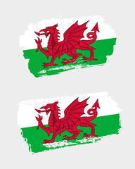 Set of two creative brush painted flags of Wales country with solid background