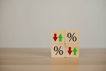 wooden block with percentage and down or up arrow