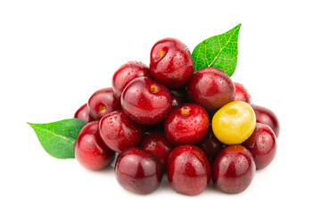 A handful of red cherries with one yellow berry. Green leaves stick out between the berries