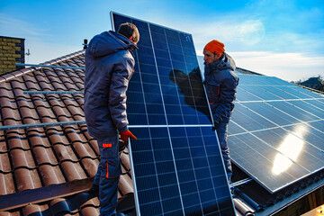 Solar panels on roof.  Installing a Solar Cell on a Roof. Workers installing solar cell farm power plant eco technology.
 - obrazy, fototapety, plakaty