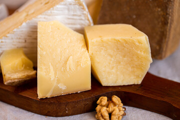 Parmesan, Goat Cheese, Brie, Camembert. Assorted cheeses on the board. Italian cheeses. Snack for wine. Cheese advertisement. Cheeseboard. Delicious cheese