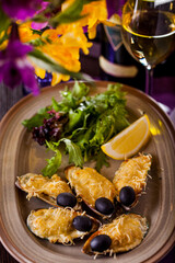 Mussels with cheese and olives and a glass of white wine