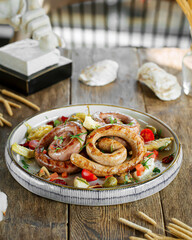 Side view on portion of grilled sausages on wooden background