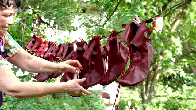 Special theatrical leather jester shoes are dried or ventilate after cleaning in backyard. Close-up. Outdoors.