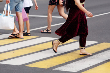 people crossing the road at a pedestrian crossing