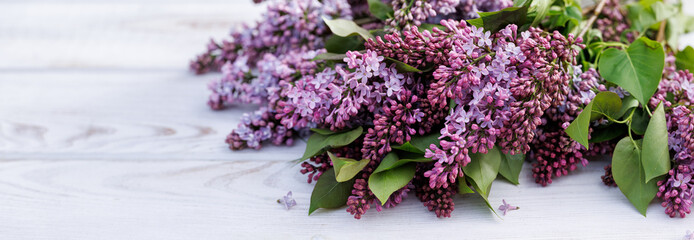 Purple lilac bouquet on white table, close up view
