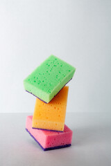 balance of multi-colored sponges for washing dishes