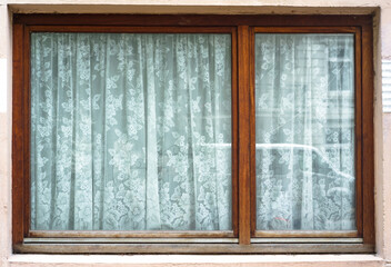 old wooden window, white fabric curtains behind glass, reflection overlay.