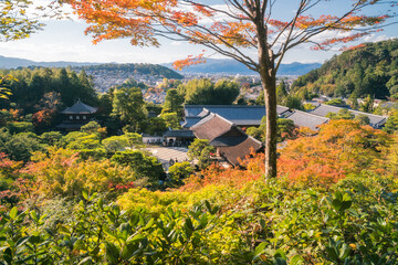Panoramic view at golden hour from the hill-top of the Silver Pavillion or Ginkaku-ji Zen Temple and gardens, and the city of Kyoto in the background in Kyoto, Japan.