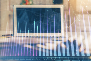 Forex market graph hologram and personal computer on background. Multi exposure. Concept of...