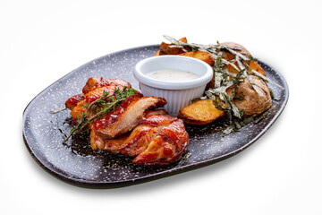 Chicken in Teriyaki sauce with roasted potatoes.In peel and garlic sauce. On a white background, isolated.