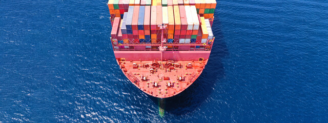 Aerial drone ultra wide photo of bow from huge fully loaded container tanker ship carrying truck...